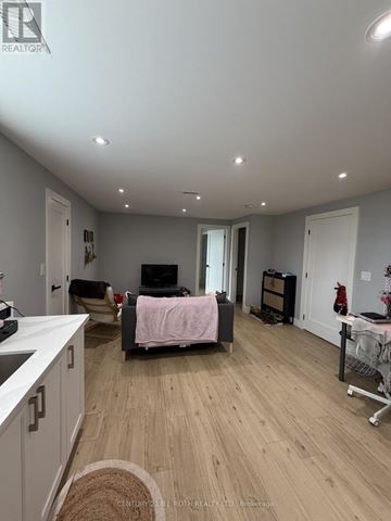 Orillia apartment for rent - A living room with a couch and a television.