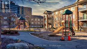 Barrie (Sunnidale) condo for rent - A playground with a slide and a green roofed structure.