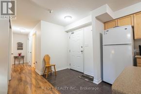 Barrie (Sunnidale) condo for rent - A small room with a white refrigerator and wooden floors.