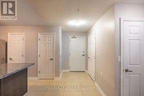 Peterborough (Ashburnham Ward 4) condo for rent - A hallway with white doors and a brokerage sign.