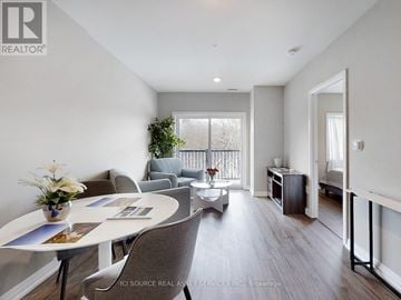 Kawartha Lakes (Lindsay) multi-family for rent - A well-lit, spacious living room with a dining table and chairs.