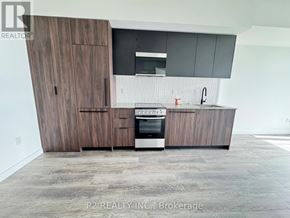 Toronto (Centennial Scarborough) condo for rent - A modern kitchen with dark wood cabinets and a stainless steel oven.