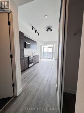 Toronto (Centennial Scarborough) condo for rent - A hallway with a kitchen visible through the door.