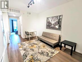 Waterloo condo for rent - A living room with a couch, chair, and rug.