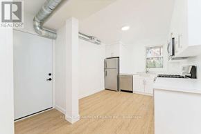 Hamilton (Stinson) multi-family for rent - A brick building with a black awning and glass doors.