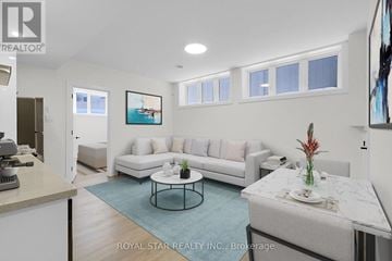 Ottawa apartment for rent - A living room with a white couch and a coffee table.