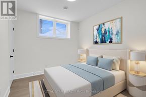Ottawa apartment for rent - A bedroom with a bed, nightstands, and a painting on the wall.