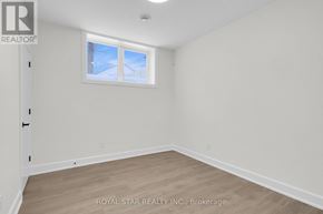 Ottawa apartment for rent - A white room with a window and wooden flooring.