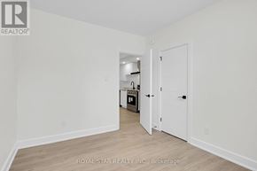 Ottawa apartment for rent - A white room with a doorway leading to another room.