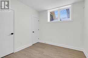 Ottawa apartment for rent - A white room with a door and a window.