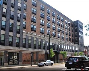Chicago apartment for rent - a large building with a car parked in front of it