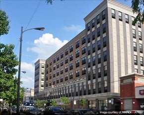 Chicago apartment for rent - a large building with cars parked in front of it