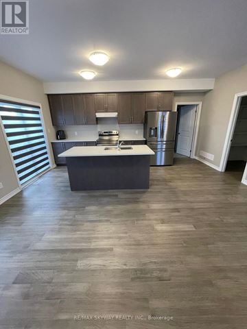 Welland (N. Welland) apartment for rent - A kitchen with a refrigerator, stove, and sink.