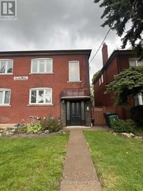 Toronto (Humewood-Cedarvale) apartment for rent - A red brick house with a black door and a sign that says "CLAIMS WOOD".