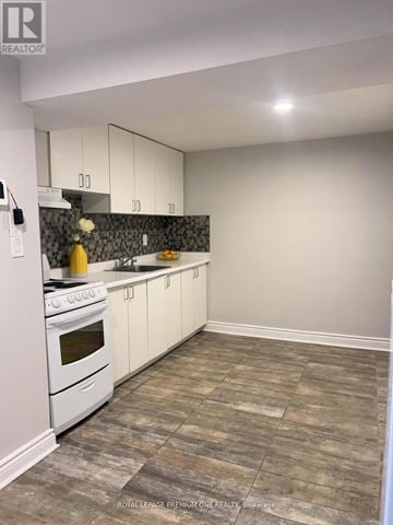 Toronto (Humewood-Cedarvale) apartment for rent - A kitchen with white cabinets and a white stove top oven.