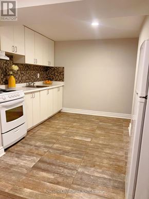 Toronto (Humewood-Cedarvale) apartment for rent - A kitchen with white appliances and a tiled floor.