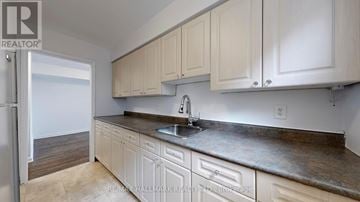 Toronto (Downsview-Roding-Cfb) apartment for rent - A kitchen with white cabinets and a sink.
