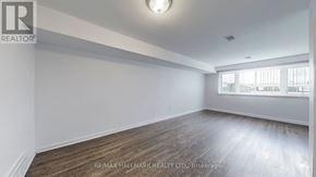 Toronto (Downsview-Roding-Cfb) apartment for rent - A spacious room with wooden flooring and white walls.