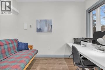 New Dundee apartment for rent - A living room with a plaid couch and a desk with a computer.