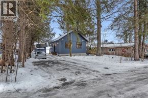 New Dundee apartment for rent - A blue house is surrounded by snow and trees.