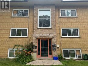 London East (East M) multi-family for rent - A brick building with a red door and windows on the second floor.