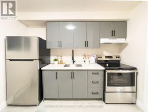 London East (East M) multi-family for rent - A kitchen with a refrigerator, sink, and oven.