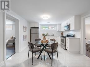 Toronto (Bathurst Manor) apartment for rent - A modern kitchen with a dining table set for four.