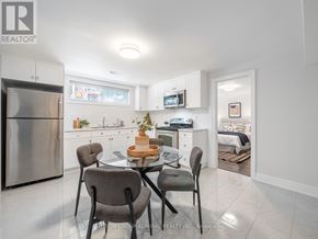 Toronto (Bathurst Manor) apartment for rent - A modern kitchen with a dining table set for four.