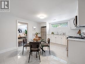 Toronto (Bathurst Manor) apartment for rent - A kitchen with a dining table and chairs in the foreground.