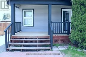 Oshawa (Central) duplex for rent - A small house with a porch and a window.