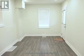 Oshawa (Central) duplex for rent - A room with a wooden floor and white walls.