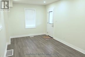 Oshawa (Central) duplex for rent - A room with a door, window, and a rug on the floor.