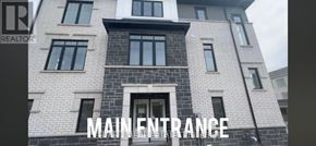 Clarington (Bowmanville) townhouse for rent - A building with a main entrance and a sign that says "REALTOR".