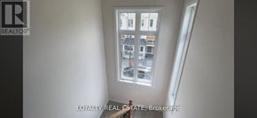 Clarington (Bowmanville) townhouse for rent - A window with a view of a street and buildings outside.