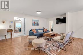 Port Hope apartment for rent - A living room with a blue couch and a wooden floor.