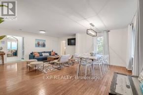 Port Hope apartment for rent - A living room with a couch, chairs, and a television.