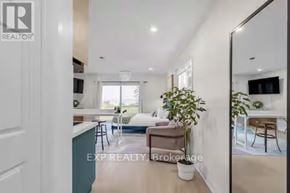 Port Hope apartment for rent - A real estate brokerage image of a modern living room with a kitchen area.