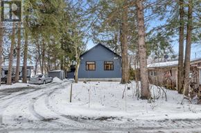 Wilmot apartment for rent - A house with a blue exterior is surrounded by snow and trees.