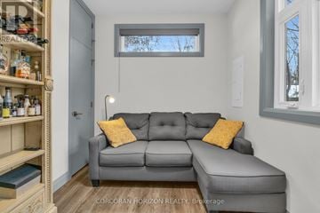 Wilmot apartment for rent - A living room with a grey couch and a wooden shelf.