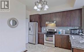 Toronto (Cliffcrest) townhouse for rent - A kitchen with a refrigerator, oven, microwave, and sink.
