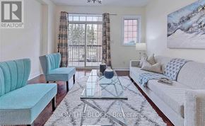 Toronto (Cliffcrest) townhouse for rent - A living room with a blue chair and a white couch.