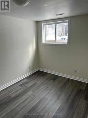 Georgina (Keswick South) apartment for rent - A room with a window and a wooden floor.