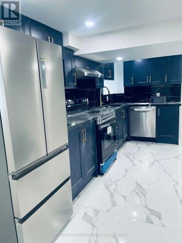 Oshawa (Lakeview) apartment for rent - A modern kitchen with a white fridge and black cabinets.