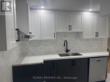 New Tecumseth (Tottenham) apartment for rent - A kitchen with white cabinets and a marble backsplash.