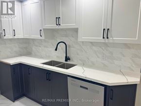 New Tecumseth (Tottenham) apartment for rent - A kitchen with white cabinets and a marble countertop.