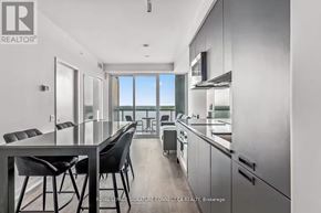 Barrie (City Centre) condo for rent - A modern kitchen with a dining table and chairs.