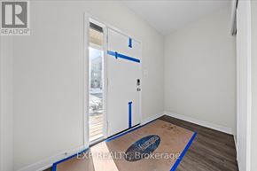Ottawa townhouse for rent - A room with a door and a window, with the words EXP REALTY Brokerage written on the floor.