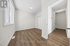 Ottawa townhouse for rent - A room with wooden flooring and white walls, with a window on the left side.