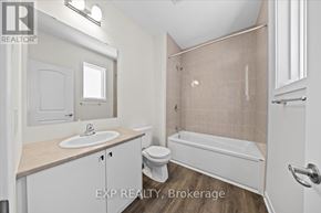 Ottawa townhouse for rent - A bathroom with a white tub, sink, and toilet.