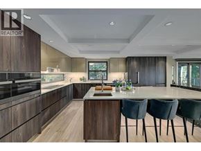 Lions Bay apartment for rent - A modern kitchen with dark wood cabinets and a central island.